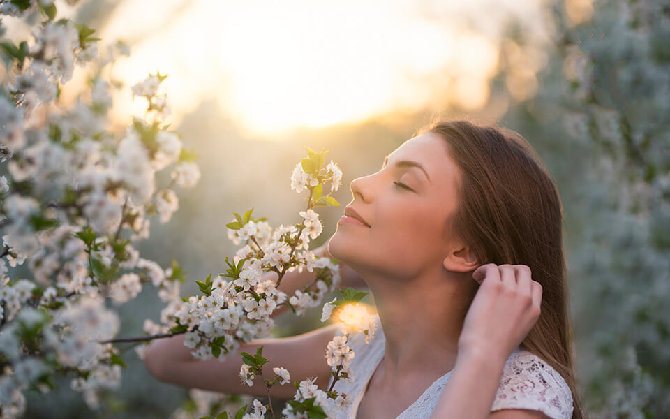 Girl smelling flower